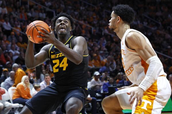 Missouri guard Kobe Brown (24) drives for a shot against Tennessee forward Olivier Nkamhoua, right, during the second half of an NCAA college basketball game Saturday, Feb. 11, 2023, in Knoxville, Tenn. (AP Photo/Wade Payne)