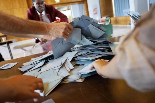 Polling effect workers originate counting ballots throughout the 2nd spherical of the legislative elections, Sunday, July 7, 2024 in Schiltgheim, eastern France. (AP Photo/Jean-Francois Badias)