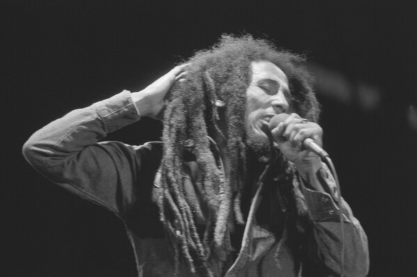 FILE - Jamaican Reggae singer Bob Marley performs in front of an audience of 40,000 during a festival concert of Reggae in Paris, France, July 4, 1980. The biopic “Bob Marley: One Love” has been a box office hit in the United States and several other countries. The film, starring Kingsley Ben-Adir, is focused on the Rastafari legend’s story during the making of his 1977 album “Exodus” while leading up to his impactful concert in his native Jamaica. (AP Photo/Jacques Langevin, File)
