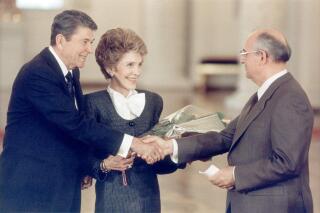 Soviet Chairman Mikhail Gorbachev, right, greets U.S. President Ronald Reagan and first lady Nancy Reagan at the Kremlin in Moscow, May 29, 1988. The Reagans arrived in the Soviet Union Sunday where Reagan and Gorbachev began their fourth summit meeting. (AP Photo/Ron Edmonds)