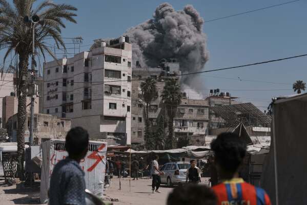 Smoke rises in the sky following an Israeli airstrike in Gaza City, Friday, May 30, 2025. (AP Photo/Jehad Alshrafi)