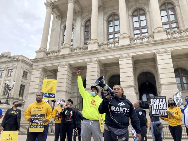 Protesters call on Georgia lawmakers to reject further changes to state voting laws on Tuesday, March 15, 2022, outside the state capitol in Atlanta. House members later approved a bill making numerous changes, sending it to the state Senate for more debate. (AP Photo/Jeff Amy)