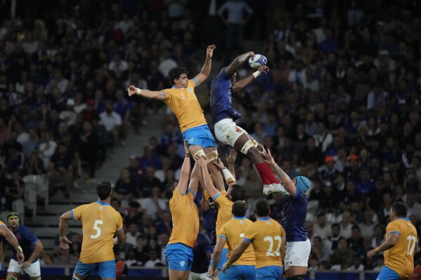 France's Sekou Macalou, top right, jumps for the ball during the Rugby World Cup Pool A match between France and Uruguay at the Pierre Mauroy stadium in Villeneuve-d'Ascq, near Lille, France, Thursday, Sept. 14, 2023. (AP Photo/Thibault Camus)