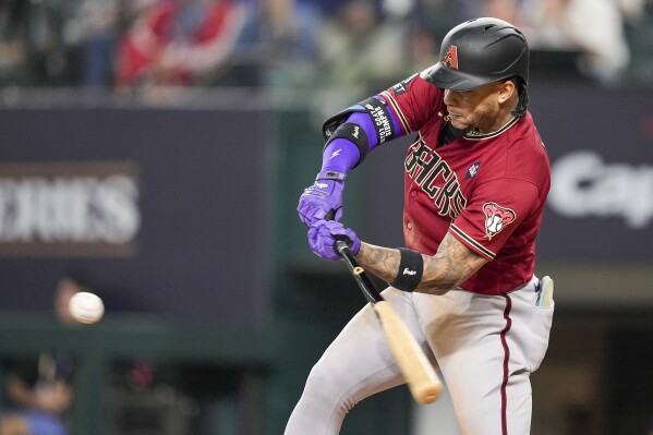 Arizona Diamondbacks' Ketel Marte hits a RBI double off Texas Rangers starting pitcher Nathan Eovaldi during the fifth inning in Game 1 of the baseball World Series Friday, Oct. 27, 2023, in Arlington, Texas. (AP Photo/Brynn Anderson)
