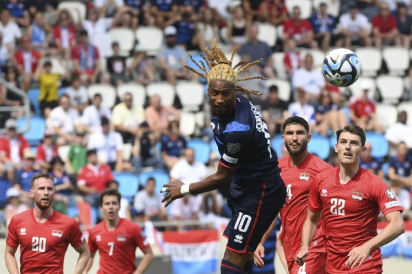 FILE - Luxembourg's Gerson Rodrigues, center, heads the ball during the Euro 2024 group J qualifying soccer match between Luxembourg and Liechtenstein at the Stade De Luxembourg in Luxembourg, on June 17, 2023. To soccer fans of a certain age, the idea of Luxembourg getting this close to qualifying for a European Championship is just incredible. Win two playoff games in five days, at Georgia on Thursday then hosting either Greece or Kazakhstan on Tuesday, and Luxembourg will be the unlikely Cinderella story at Euro 2024 in June. (AP Photo/Fred Sierakowski, File)