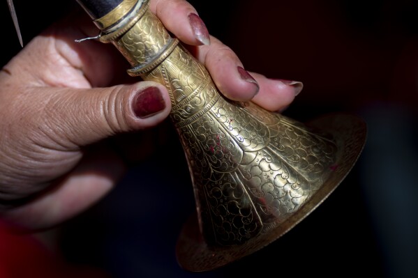A member of Shrijanshil Mahila Sanstha, or the Self-Reliant Women’s Group, holds a Sanai, a traditional musical instrument, during a rehearsal in Kathmandu, Nepal, Thursday, March 7, 2024. (AP Photo/Niranjan Shrestha)