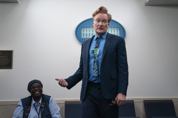 Comedian Conan O'Brien talks with journalists as he visits the White House briefing room, Friday, Dec. 15, 2023, in Washington. (AP Photo/Evan Vucci)