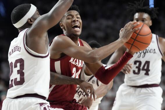 Alabama forward Brandon Miller (24) tries to drive the lane against Texas A&M guard Tyrece Radford (23) during the first half of an NCAA college basketball game Saturday, March 4, 2023, in College Station, Texas. (AP Photo/Sam Craft)