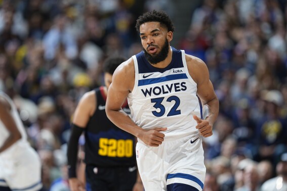 Minnesota Timberwolves center Karl-Anthony Towns (32) turns back on defense after hitting a basket in the first half of Game 2 of an NBA basketball second-round playoff series against the Denver Nuggets, Monday, May 6, 2024, in Denver. (AP Photo/David Zalubowski)