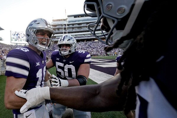Kansas State quarterback Will Howard, left, celebrates with teammates after scoring a touchdown during the first half of an NCAA college football game against Southeast Missouri State Saturday, Sept. 2, 2023, in Manhattan, Kan. (AP Photo/Charlie Riedel)