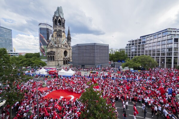 Turkey's fans gather for a fan meeting at Breitscheidplatz before the start of the Euro 2024 quarterfinal soccer match between Netherlands and Turkey in Berlin, Saturday, July 6, 2024. (Christoph Soeder/dpa via AP)