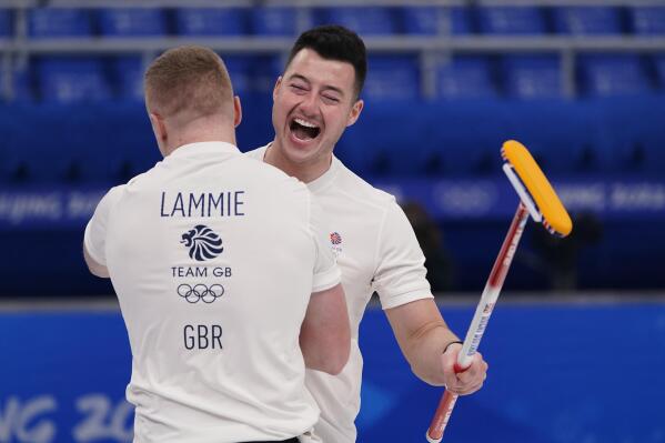 Britain's Hammy McMillan celebrates with Bobby Lammie after winning the men's curling semifinal match against the United States at the Beijing Winter Olympics Thursday, Feb. 17, 2022, in Beijing. (AP Photo/Brynn Anderson)