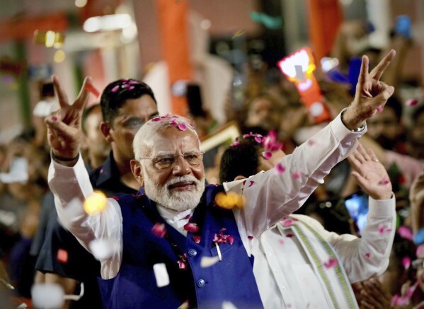 Prime Minister Narendra Modi greets supporters as he arrives at Bharatiya Janata Party (BJP) headquarters in New Delhi, India, Tuesday, June 4, 2024. (AP Photo/Manish Swarup)