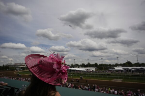 A race fan watches from the stands at Churchill Downs before the 151st running of the Kentucky Oaks horse race Friday, May 2, 2025, in Louisville, Ky. (AP Photo/Brynn Anderson)