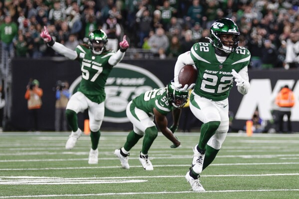 New York Jets' Tony Adams, right, runs with the ball after an interception during the second half of an NFL football game against the Philadelphia Eagles, Sunday, Oct. 15, 2023, in East Rutherford, N.J. (AP Photo/Adam Hunger)