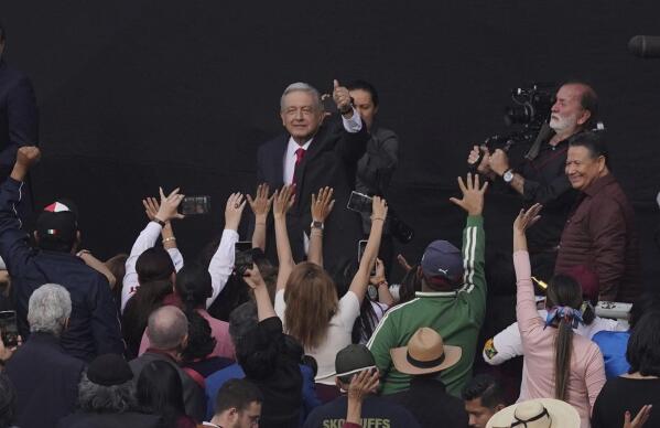Mexican President Andres Manuel Lopez Obrador greets supporters as he arrives to attend a rally to commemorate the 85th anniversary of the 1938 expropriation of the country's oil industry, at the Zocalo in Mexico City, Saturday, March 18, 2008. (AP Photo/Marco Ugarte)