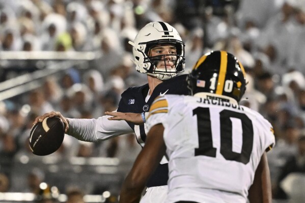 Penn State quarterback Drew Allar (15) throws a touchdown pass to tight end Khalil Dinkins (16) during the first half of an NCAA college football game against Iowa, Saturday, Sept. 23, 2023, in State College, Pa. (AP Photo/Barry Reeger)