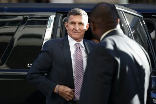 FILE - In this Dec. 18, 2018, file photo, President Donald Trump's former National Security Advisor Michael Flynn arrives at federal court in Washington. A former federal judge appointed to review the Justice Department's motion to dismiss criminal charges against ex-national security Michael Flynn has found that the government's request should be denied because there is “clear evidence of a gross abuse of prosecutorial power.”  Former U.S. District Judge John Gleeson says in a filing Wednesday that the government “has engaged in highly irregular conduct to benefit a political ally of the President.” (AP Photo/Carolyn Kaster, File)