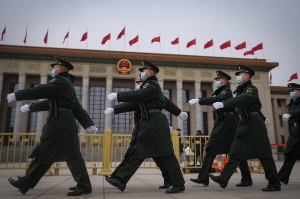 Chinese soldiers march past the Great Hall of the People during a preparatory session of the National People's Congress (NPC) in Beijing, Monday, March 4, 2024. (AP Photo/Andy Wong)