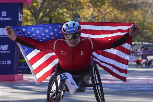 Daniel Romanchuk poses for photos after winning the men's wheelchair division of the New York City Marathon, Nov. 3, 2024, in New York. (AP Photo/Frank Franklin II, File)