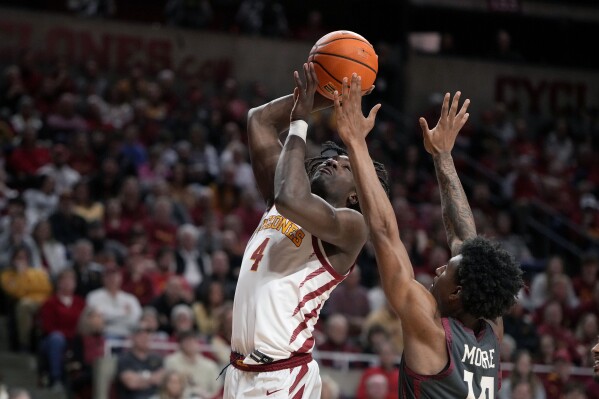 Iowa State guard Demarion Watson (4) shoots as Oklahoma forward Jalon Moore (14) defends during the second half of an NCAA college basketball game Wednesday, Feb. 28, 2024, in Ames, Iowa. (AP Photo/Matthew Putney)