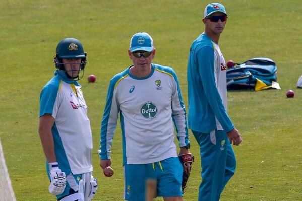 FILE - Australia's test squad skipper Pat Cummins, left, interim coach Andrew McDonald, center, and Ashton Agar attend a practice session at the Pindi Stadium, in Rawalpindi, Pakistan, March 2, 2022. McDonald has been named head coach of the Australian men's cricket team, Wednesday April 13, 2022, on a four-year contract. (AP Photo/Anjum Naveed,File)