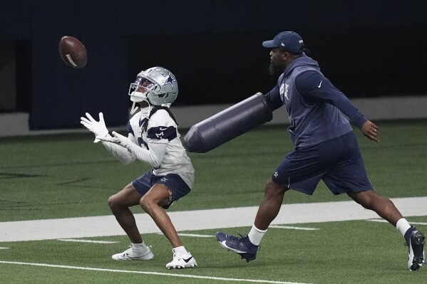FILE - Dallas Cowboys' KaVontae Turpin, left, works a special teams kick return drill during an NFL football team practice in Frisco, Texas, Wednesday, May 22, 2024. The NFL is bringing the kickoff back to life, starting with teams investing time in offseason workouts — with plans for plenty more in training camps — into something that had become a pointless exercise. (AP Photo/LM Otero, File)