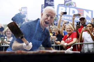 FILE - In this Sept. 21, 2019, file photo when former Vice President Joe Biden was running for president, Biden works the grill during the Polk County Democrats Steak Fry in Des Moines, Iowa. President Joe Biden spent only a weekend as the "Hamburglar" in the conservative media world, but the incident illustrated the speed at which a false and damaging story can spread. The Daily Mail wrote about things that could potentially be in a Biden climate change plan, and cited an academic study that mentioned reductions in greenhouse gases that could be achieved with limits on beef consumption. (AP Photo/Charlie Neibergall)