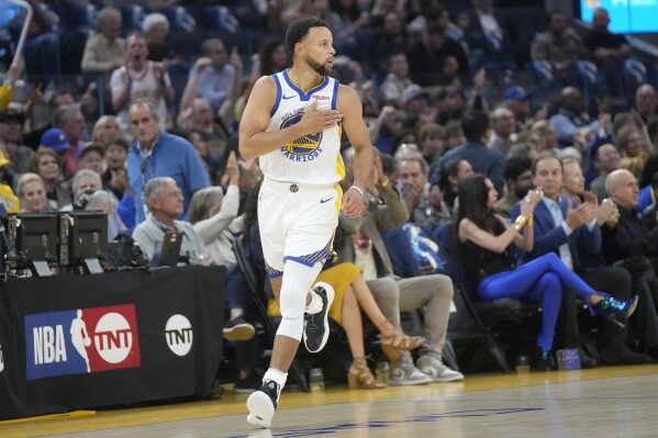 Golden State Warriors guard Stephen Curry gestures after making a 3-point basket against the Phoenix Suns during the first half of an NBA basketball game in San Francisco, Tuesday, Oct. 24, 2023. (AP Photo/Jeff Chiu)
