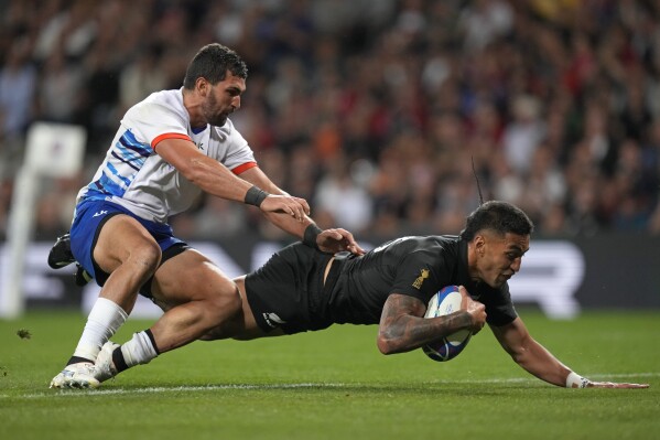 New Zealand's Rieko Ioane scores a try during the Rugby World Cup Pool A match between New Zealand and Namibia at the Stadium de Toulouse in Toulouse, France, Friday, Sept. 15, 2023. (AP Photo/Themba Hadebe)