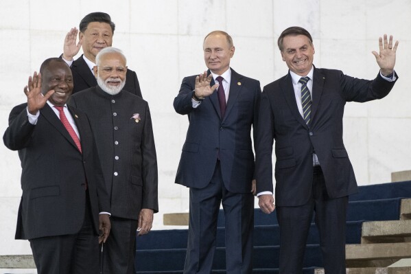 FILE - From left to right, South Africa's President Cyril Ramaphosa, China's President Xi Jinping, India's Prime Minister Narendra Modi, Russia's President Vladimir Putin and Brazil's President Jair Bolsonaro pose for a photo at the BRICS emerging economies at the Itamaraty palace in Brasilia, Brazil, Thursday, Nov. 14, 2019. Russia and China will look to gain more political and economic ground in the developing world at a summit of the BRICS bloc in South Africa this week. Putin will take part in the main summit on Wednesday, Aug. 23, 2023 via video link after an International Criminal Court arrest warrant complicated his travel to South Africa. (AP Photo/Pavel Golovkin, Pool, File)