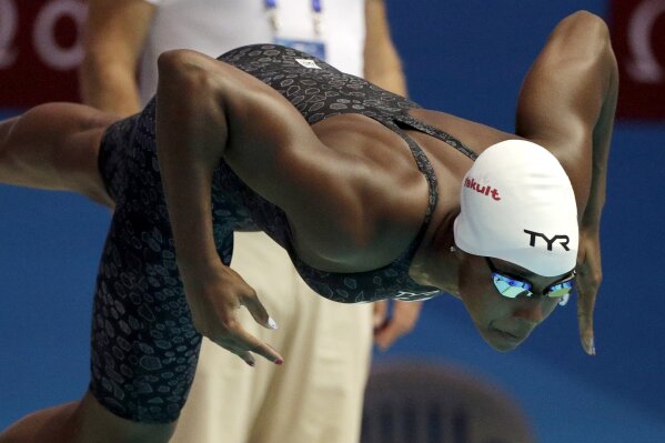FILE - In this July 27, 2019, file photo, United States' Simone Manuel starts a heat of the women's 50-meter fresstyle at the World Swimming Championships in Gwangju, South Korea. Manuel joined with fellow Olympians Sue Bird, Chloe Kim and Alex Morgan to launch TOGETHXR, a media and commerce company aimed at girls and women. It will create content for social media platforms like Instagram and TikTok as well as its own YouTube channel. Billie Jean King cheered its announcement this week. “I can’t wait to share everything we have in store," Manuel tweeted earlier this week. “ (AP Photo/Mark Schiefelbein, File)