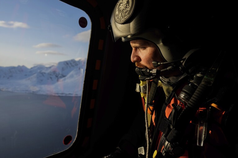 French Chief Petty officer Julien looks on during a flight to join the French navy frigate Normandie in a Norwegian fjord, north of the Arctic circle, for a reconnaissance patrol, Wednesday March 6, 2024. The French frigate is part of a NATO force conducting exercices in the seas, north of Norway, codenamed Steadfast Defender, which are the largest conducted by the 31 nation military alliance since the cold war. (AP Photo/Thibault Camus)