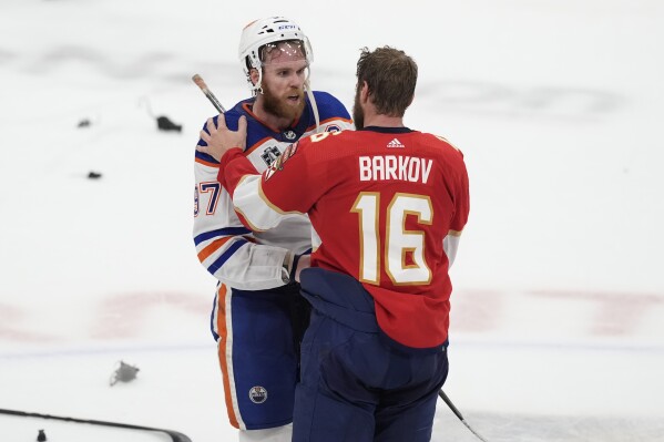 Florida Panthers center Aleksander Barkov (16) talks to Edmonton Oilers center Connor McDavid (97) at the end of Game 7 of the NHL hockey Stanley Cup Final, Monday, June 24, 2024, in Sunrise, Fla. (AP Photo/Rebecca Blackwell, File)