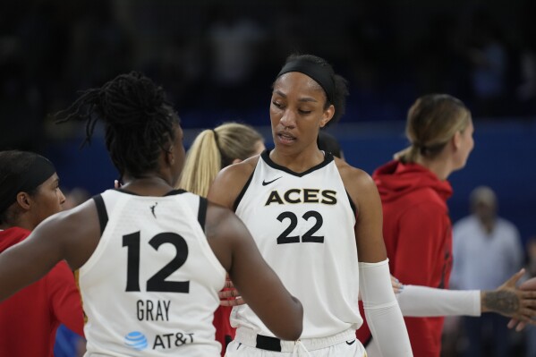 Las Vegas Aces forward A'ja Wilson, right, and guard Chelsea Gray celebrate their 107-95 victory over the Chicago Sky in a WNBA basketball game Tuesday, July 25, 2023, in Chicago. (AP Photo/Erin Hooley)