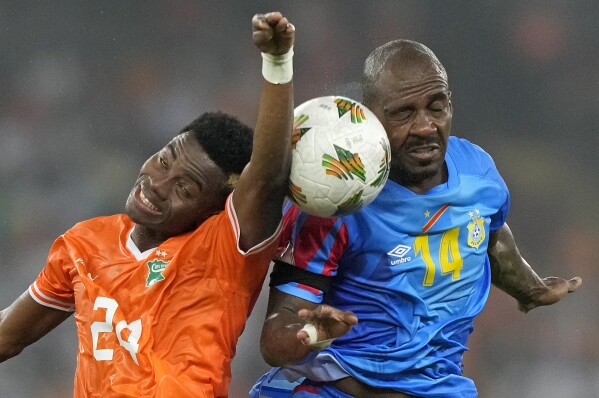 DR Congo's Gael Kakuta, right, battles for the ball with Ivory Coast's Simon Adingra during the African Cup of Nations semifinal soccer match between Ivory Coast and DR Congo, at the Olympic Stadium of Ebimpe in Abidjan, Ivory Coast, Wednesday, Feb. 7, 2024. (APPhoto/Sunday Alamba)
