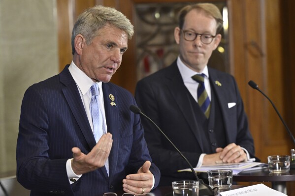 Foreign Minister Tobias Billström, background, listens, during a press briefing together with US congressmen Michael McCaul, foreground and Gregory Meeks, in Stockholm, Friday, Sept. 1, 2023. The United States House Foreign Affairs chair says that a partnership of the Russian and Chinese leaders worries him, saying: “We have never seen a threat this large-scale to Europe and the Pacific, I would argue, since World War II.” Rep. Michael McCaul, R-Texas, said Friday during a trip to Sweden with a U.S. Congressional Delegation that an alliance of Beijing and Moscow poses a big challenges to the free world. (Henrik Montgomery/TT News Agency via AP)