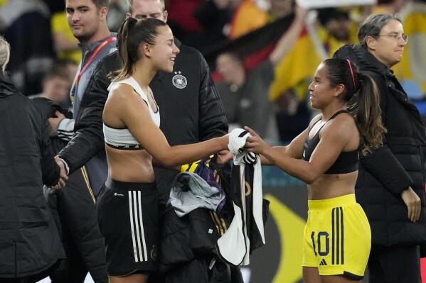 Germany's Lena Oberdorf and Colombia's Leicy Santos, right, exchange shirts at the end of the Women's World Cup Group H soccer match between Germany and Colombia at the Sydney Football Stadium in Sydney, Australia, Sunday, July 30, 2023. Colombia won 2-1. (AP Photo/Mark Baker)