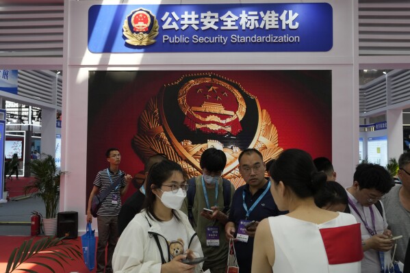 Visitors pass near the booth for the Chinese police department setting standards for security technologies during the Security China 2023 in Beijing, on June 7, 2023. After years of breakneck growth, China's security and surveillance industry is now focused on shoring up its vulnerabilities to the United States and other outside actors, worried about risks posed by hackers, advances in artificial intelligence and pressure from rival governments. The renewed emphasis on self-reliance, combating fraud and hardening systems against hacking was on display at the recent Security China exhibition in Beijing. (AP Photo/Ng Han Guan)