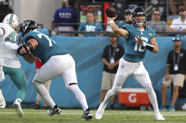 Jacksonville Jaguars quarterback Trevor Lawrence (16) stands back to pass during the first half of an NFL preseason football game against the Miami Dolphins, Saturday, Aug. 26, 2023, in Jacksonville, Fla. (AP Photo/Gary McCullough)
