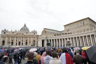 FILE - Faithful gather to listen to Pope Francis' Angelus noon prayer in St. Peter's Square, at the Vatican, Sunday, Nov. 14, 2021. The Vatican’s big fraud and embezzlement trial, which opened to great fanfare in July, suffered another delay Tuesday, Dec. 14, 2021 as the tribunal postponed any further decisions until prosecutors finish redoing their investigation for four of the original 10 defendants.   (AP Photo/Gregorio Borgia, File)