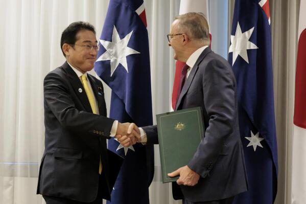 Australian Prime Minister Anthony Albanese, right, shakes hands with Japan's Prime Minister Fumio Kishida after signing a new joint declaration on security cooperation, in Perth, Australia, Saturday, Oct. 22, 2022. (Richard Wainwright/AAPImage via AP)