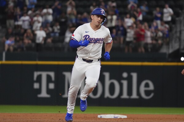Texas Rangers' Wyatt Langford runs the bases after hitting a home run during the sixth inning of a baseball game against the Colorado Rockies, Monday, May 12, 2025, in Arlington, Texas. (AP Photo/LM Otero)