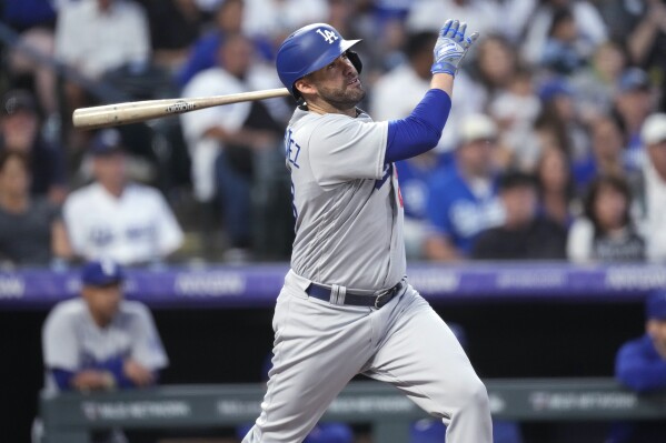 FILE - Los Angeles Dodgers' J.D. Martinez watches his two-run home run off Colorado Rockies starting pitcher Chris Flexen during the first inning of a baseball game Sept. 28, 2023, in Denver. Martinez has a new home, agreeing to a $12 million, one-year contract with the New York Mets on Thursday, March 21, according to a person familiar with the deal. The person spoke to The Associated Press on condition of anonymity because the agreement was pending a physical. (AP Photo/David Zalubowski, File)