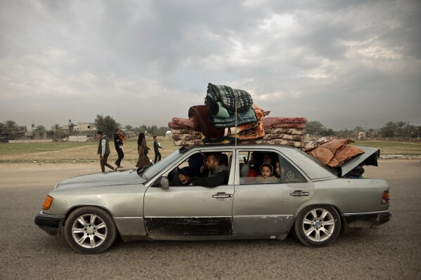 A Palestinian family flee the Israeli ground offensive in Khan Younis, Gaza Strip, Wednesday, Dec. 27, 2023. (AP Photo/Mohammed Dahman)