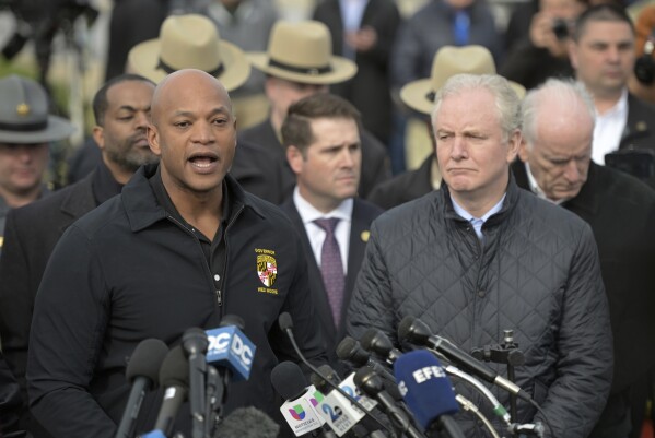 Maryland Gov. Wes Moore, left, speaks during a news conference as Sen. Chris Van Hollen (D-MD) looks on near the scene where a container ship collided with a support on the Francis Scott Key Bridge, Tuesday, March 26, 2024 in Baltimore. (AP Photo/Steve Ruark)