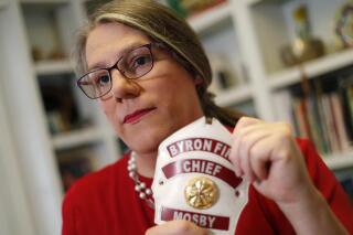 HFM TBA**FILE-In this Sept. 26, 2019, file photo, former Byron, Ga., fire chief Rachel Mosby poses for a photo in the home of a friend in Atlanta. Mosby is a transgender woman who held the job for more than a decade as a man, then was fired in June, 18 months after she openly transitioned. Mosby has filed a discrimination lawsuit in 2020, in U.S. District Court after the EEOC took no action on a sex discrimination complaint she filed last year.(AP Photo/John Bazemore, File)