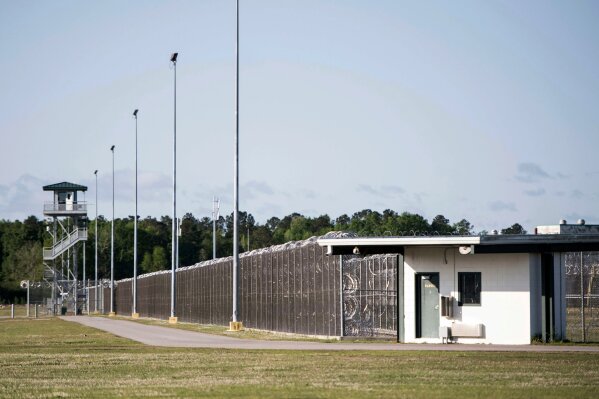 
              FILE - This April 16, 2018 file photo shows the Lee Correctional Institution in Bishopville, S.C. In 2018, seven inmates at the maximum-security South Carolina prison were killed in what officials have said was a gang fight over territory and contraband including cellphones. Federal legislation proposed Thursday, March 28, 2019, would give state prison officials the ability they have long sought to jam the signals of cellphones smuggled to inmates within their walls.   (AP Photo/Sean Rayford, File)
            