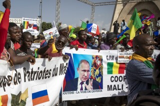 FILE - Malians demonstrate against France and in support of Russia on the 60th anniversary of the independence of the Republic of Mali, in Bamako, Mali, Sept. 22, 2020. The Russian mercenary group that briefly rebelled against President Vladimir Putin’s authority has for years been a ruthless force-for-hire across Africa, protecting rulers at the expense of the masses. That dynamic is not expected to change now that the group’s founder, Yevgeny Prigozhin, has been exiled to Belarus as punishment for the failed rebellion. Neither Russia nor the African leaders dependent on Wagner’s fighters have any interest in ending their relationships. (AP Photo/File)