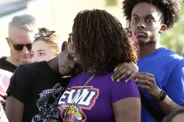 Residents gather at a prayer vigil for the victims of a mass shooting a day earlier, in Jacksonville, Fla., Sunday, Aug. 27, 2023. (AP Photo/John Raoux)